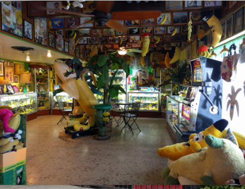 A colorful room filled with banana-themed decor, plush toys, and display cases showcasing various banana-related items.