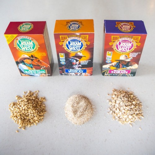 Three colorful cereal boxes labeled "Ranch Oats," "Wheat," and "Zein," with piles of oats, wheat, and flour below.
