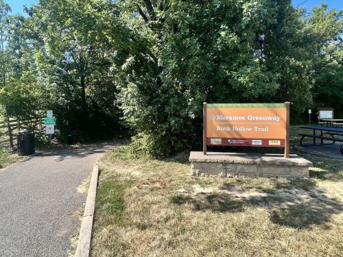 Sign for the Murranji Greensway and Rock Hollow Trail, with a path leading into a wooded area.
