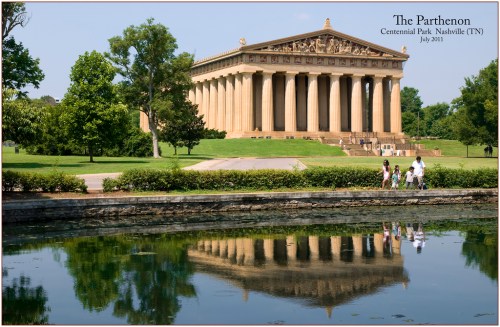 The Parthenon replica in Centennial Park, Nashville, surrounded by greenery and reflecting in a pond.