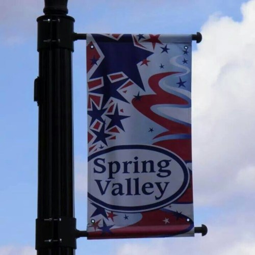 A decorative banner for Spring Valley featuring stars and swirls in red, white, and blue colors.