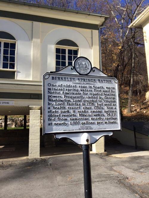 Historical marker for Berkeley Springs Baths, highlighting its significance as a natural spring and spa since 1776.