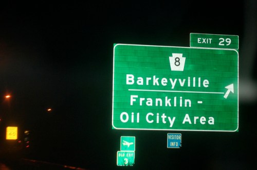 Green highway sign indicating exit 29 for Barkeyville and Franklin - Oil City Area, with directional arrow.