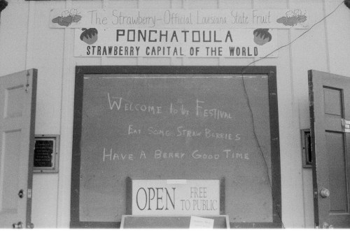 Signboard for the Ponchatoula Strawberry Festival, featuring welcoming messages and "Open" notice.
