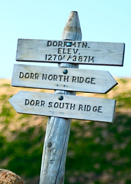 Wooden signpost with directions to Dorr Mountain, Dorr North Ridge, and Dorr South Ridge, with elevation marked.