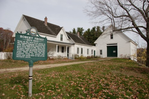 Historic site of Robert Frost's home, featuring a sign with his name and dates, surrounded by autumn foliage.