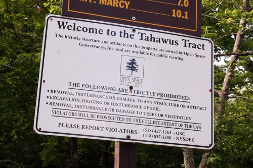 Sign at Tahawus Tract outlining prohibited activities and contact information for reporting violations.
