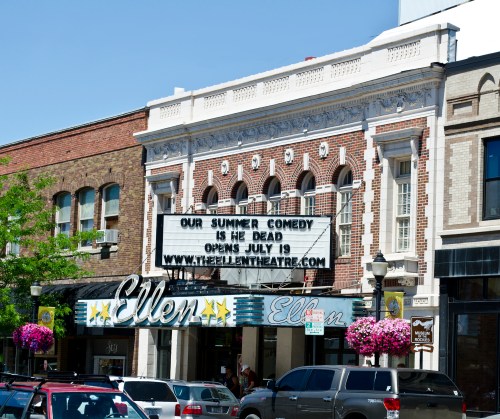The Ellen Theatre marquee announces "Our Summer Comedy: Is He Dead?" opening July 19, with colorful flowers in front.