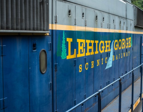 Blue train car with "Lehigh Gorge Scenic Railway" painted in yellow and green letters.