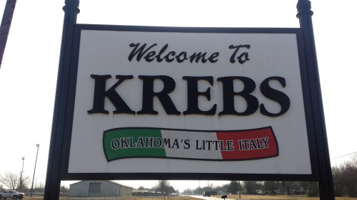 Welcome sign for Krebs, Oklahoma, featuring the phrase "Oklahoma's Little Italy" with an Italian flag design.