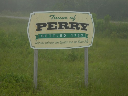 Sign for the Town of Perry, established in 1763, stating it's halfway between the Equator and the North Pole.