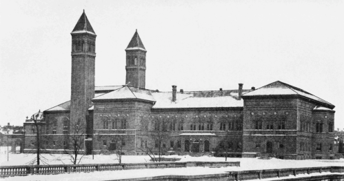 Historic building with two towers, surrounded by snow, showcasing architectural details from an earlier era.