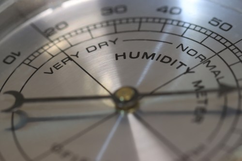 Close-up of a humidity gauge showing levels from "Very Dry" to "Normal."