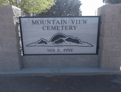 Sign for Mountain View Cemetery, featuring mountains and the address 3410 E. Pine.