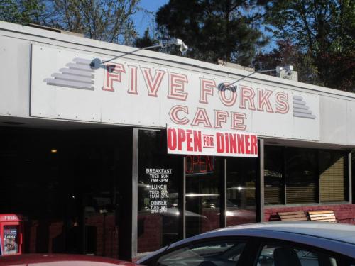 Sign for Five Forks Cafe, featuring "OPEN FOR DINNER" in bright letters, with hours listed for breakfast, lunch, and dinner.