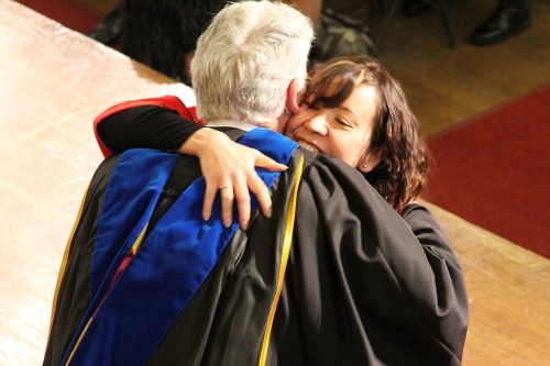 Student hugging professor at graduation