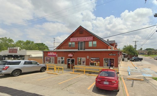 A red-brick restaurant with a sign reading "R & O's Restaurant," surrounded by parked cars and a cloudy sky.