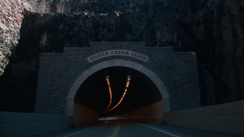 A stone tunnel entrance labeled "Silver Creek Cliff" with a winding road leading into darkness.