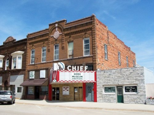 Historic building featuring the Chief Theater and Hobo Museum, with a brick facade and colorful marquee.