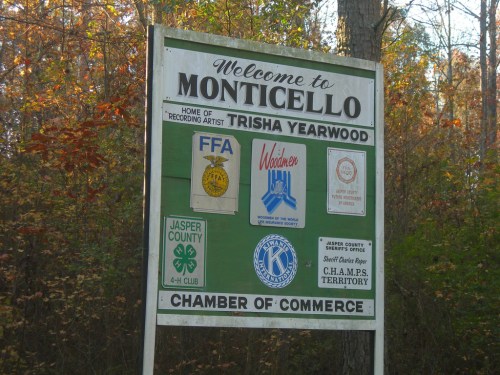 Welcome sign for Monticello, featuring logos for local organizations and a mention of Trisha Yearwood.