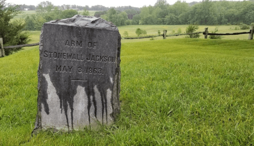 A weathered stone monument marking the Arm of Stonewall Jackson, dated May 3, 1863, set in a grassy landscape.
