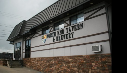 Exterior of North End Tavern & Brewery, featuring a modern design with stone accents and a prominent sign.