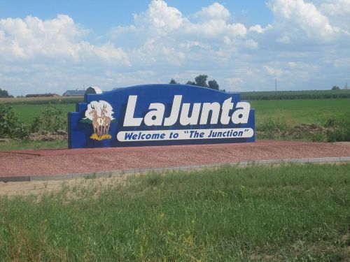 Welcome sign for La Junta, featuring an eagle and the text "Welcome to 'The Junction'" against a green landscape.