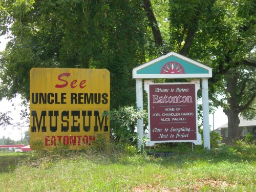 Two signs: one for Uncle Remus Museum and another welcoming visitors to historic Eatonton, Georgia.