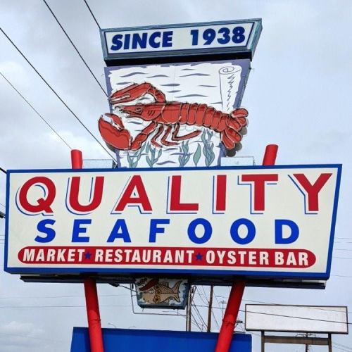 Sign for Quality Seafood, featuring a lobster graphic, with "Market, Restaurant, Oyster Bar" and "Since 1938."