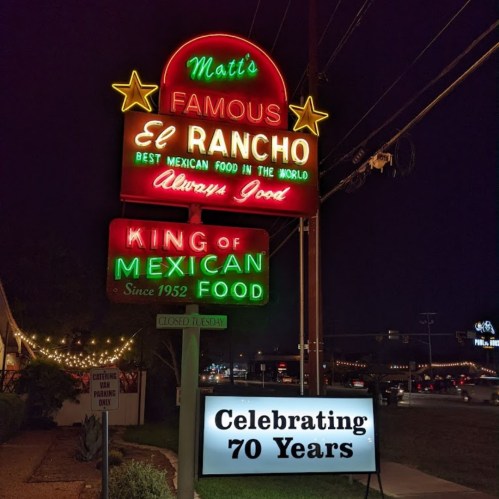 Colorful neon sign for Matt's El Rancho, celebrating 70 years of serving Mexican food, illuminated at night.