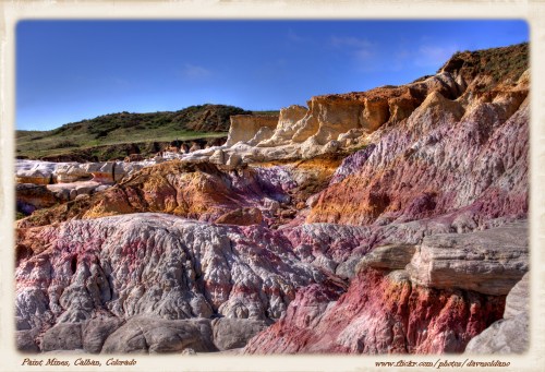 Colorful rock formations at Paint Mines, Calhan, Colorado, showcasing vibrant hues against a clear blue sky.