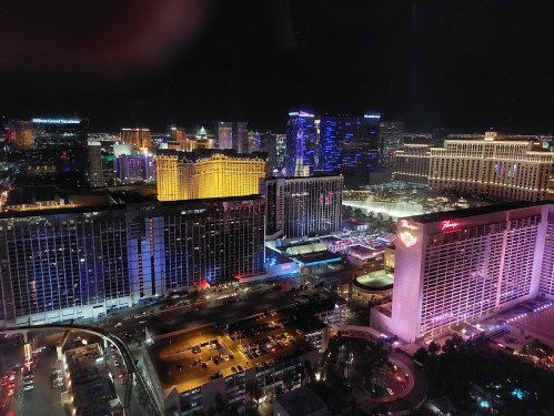 A nighttime view of the Las Vegas Strip, showcasing illuminated hotels and vibrant city lights.