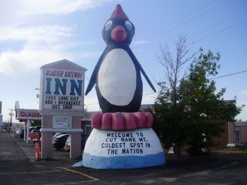 A large penguin statue stands outside the Glacier Gateway Inn, welcoming visitors to Cut Bank, Montana, the coldest spot in the nation.