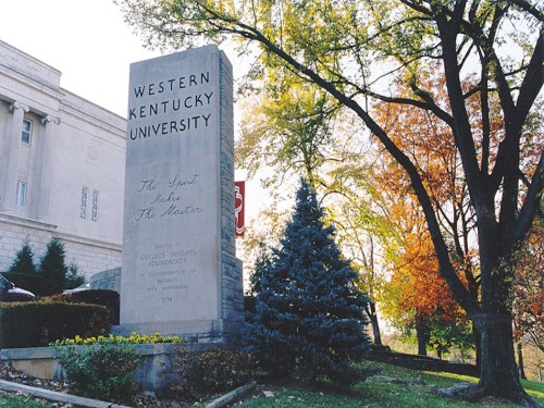 Stone monument at Western Kentucky University surrounded by trees and autumn foliage.
