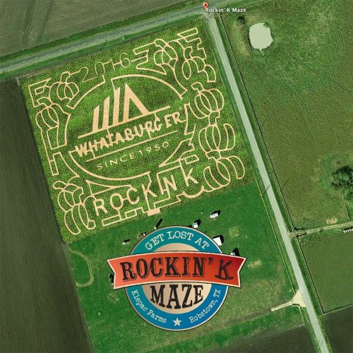 Aerial view of a corn maze featuring a design with "Rockin' K" and "Whataburger" logos, surrounded by fields.