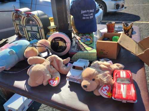 A table of assorted items including stuffed animals, a jukebox, a cap, and various small collectibles.