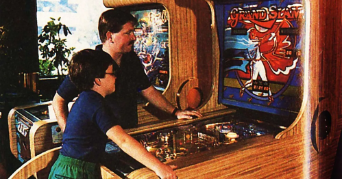A man and a boy play a vintage pinball machine titled "Grand Slam" in a retro arcade setting.