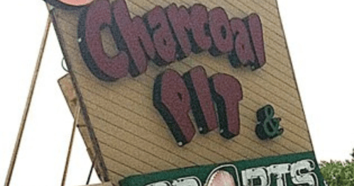 Sign for "Charcoal Pit & Sports" with bold, colorful lettering.