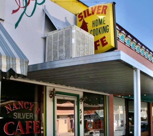 Sign for "Silver Home Cooking Cafe" on a building with a striped awning and air conditioning unit.