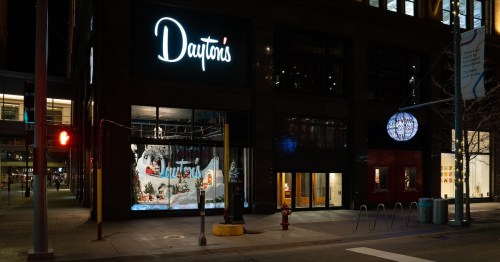 Night view of Dayton's building with festive window display and illuminated signage.