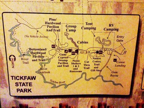 Map of Tickfaw State Park showing trails, camping areas, cabins, and facilities like restrooms and a nature center.