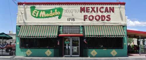 Colorful exterior of El Modelo Mexican Foods, featuring green and red awnings and a vibrant sign, located at 1715.