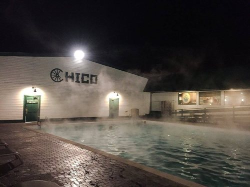 A misty night scene of a pool outside a building labeled "HICO," with steam rising from the water.