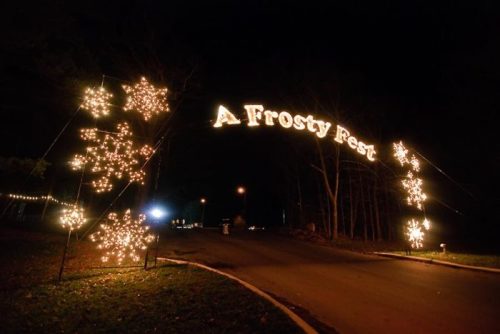 A festive archway of lights reading "A Frosty Fest" with snowflake decorations, set against a dark night sky.