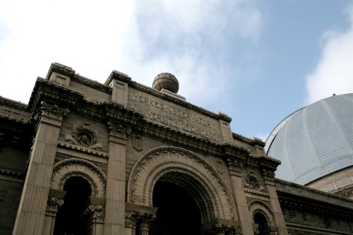 The Yerkes Observatory entrance at the University of Chicago, featuring ornate architecture and a dome in the background.