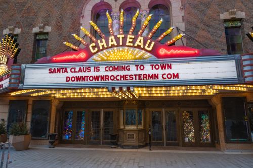 Marquee of the Chateau theater announcing "Santa Claus is Coming to Town" with bright lights and a decorative design.