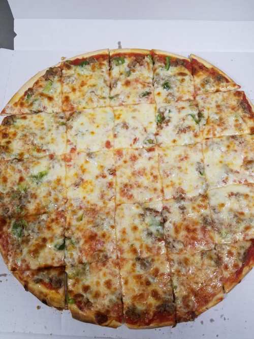 A large pizza topped with cheese, green peppers, and sausage, cut into 16 slices in a pizza box.