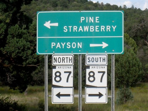 Green highway sign indicating directions to Pine, Strawberry, and Payson, with arrows for North and South on Route 87.