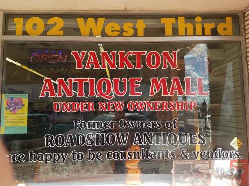 Sign for Yankton Antique Mall, stating "Under New Ownership" and mentioning former owners of Roadshow Antiques.