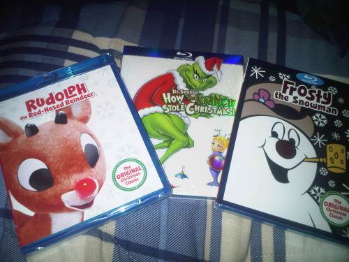 Three Blu-ray cases featuring "Rudolph the Red-Nosed Reindeer," "How the Grinch Stole Christmas," and "Frosty the Snowman."